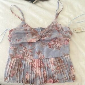 Floral, flowy top. Zip back. Medium size. Brand new never worn